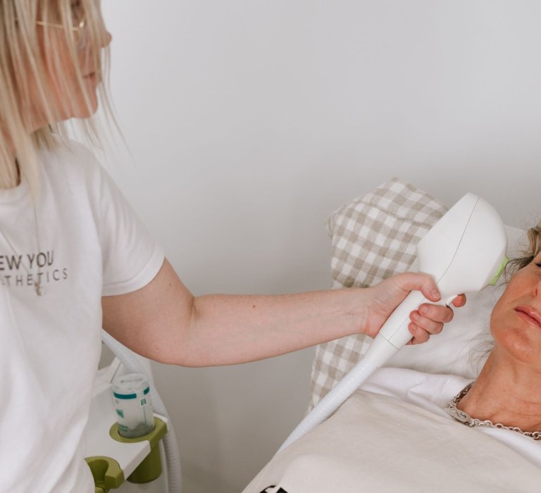 lady receiving IPL treatment from New You professional