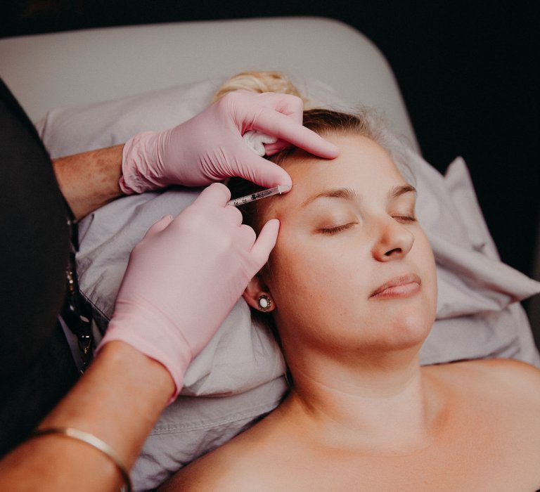 Woman with eyes closed as she lays down