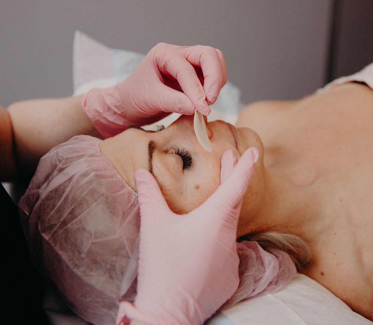 New You staff member removes eye covers from client