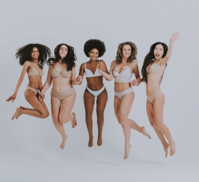 Five women jumping in the air