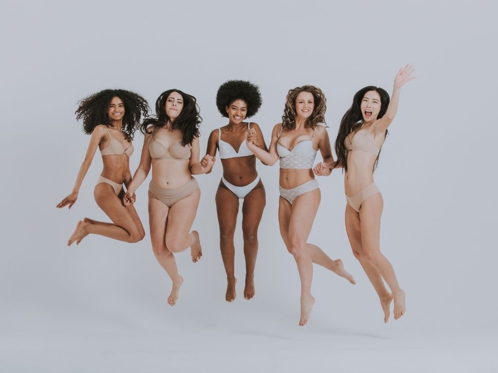 Five women jumping in the air