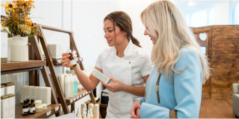 A skin technician and a client go through skin care products together
