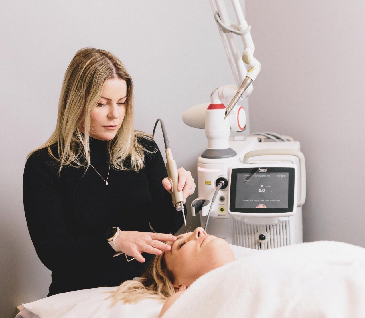 New You staff member does laser on a client