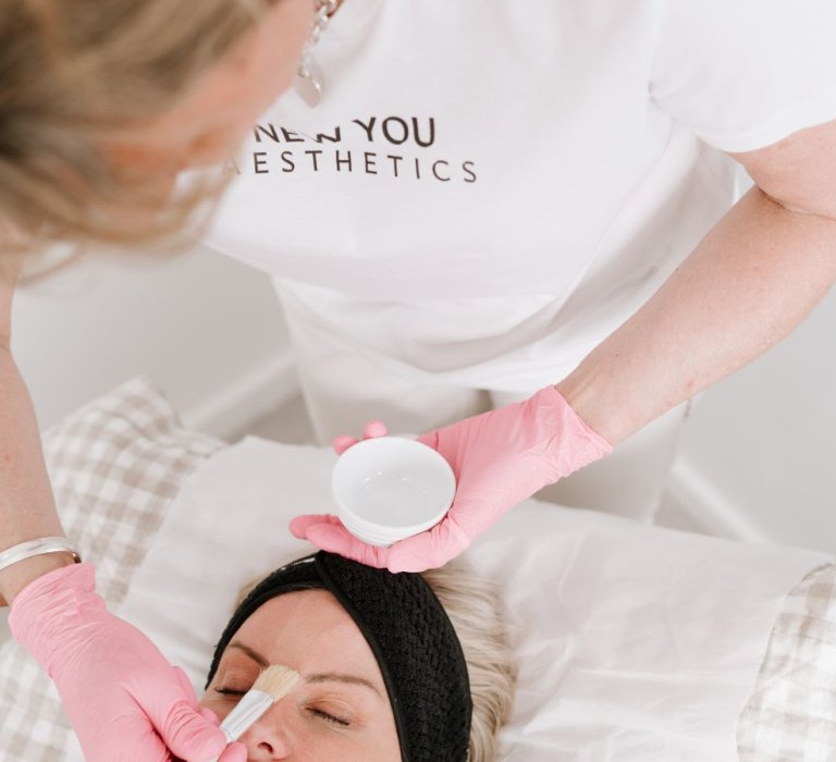 A beautician doing a skin treatment on a customer