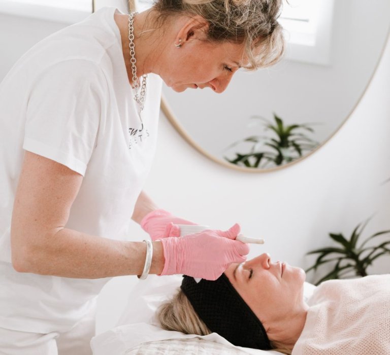 A beautician doing a skin treatment on a customer