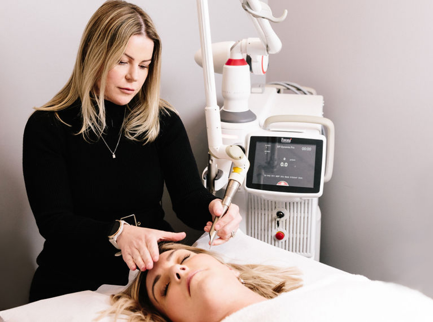 A woman receiving a skin treatment