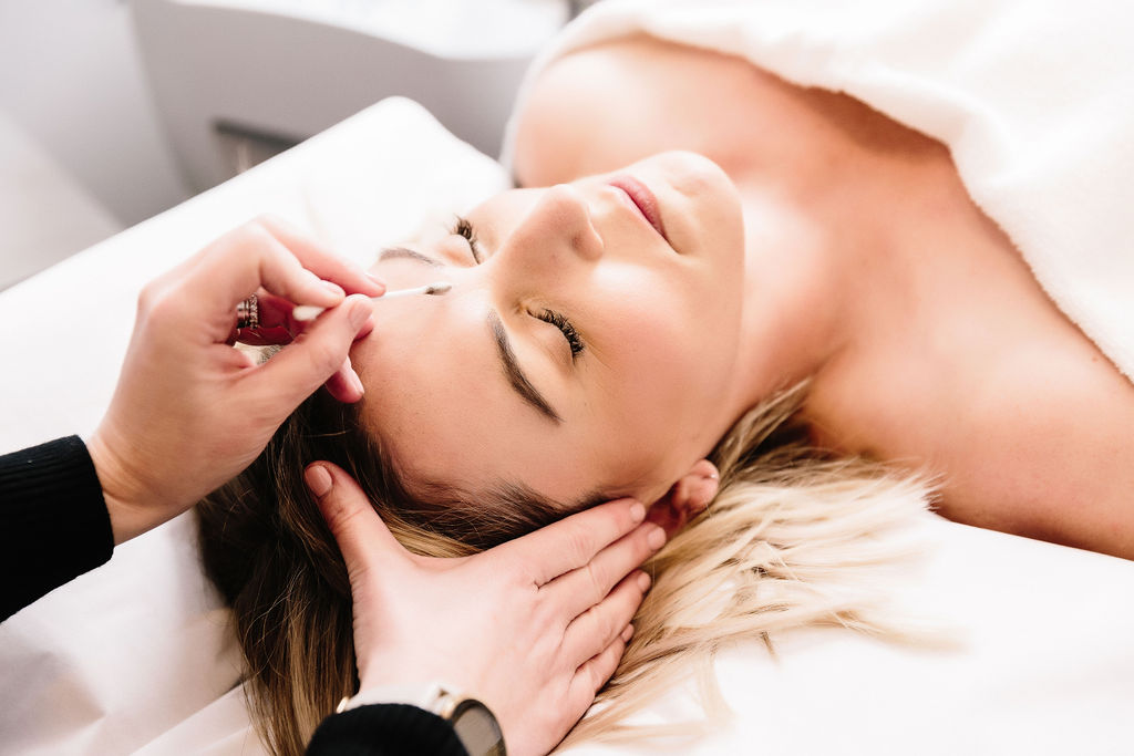 A woman receiving a head massage