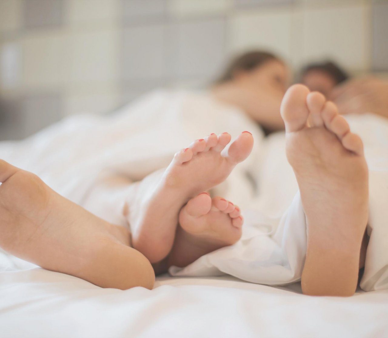 Two people lying in bed