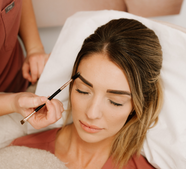 lady getting her eye brows done by a New You professional